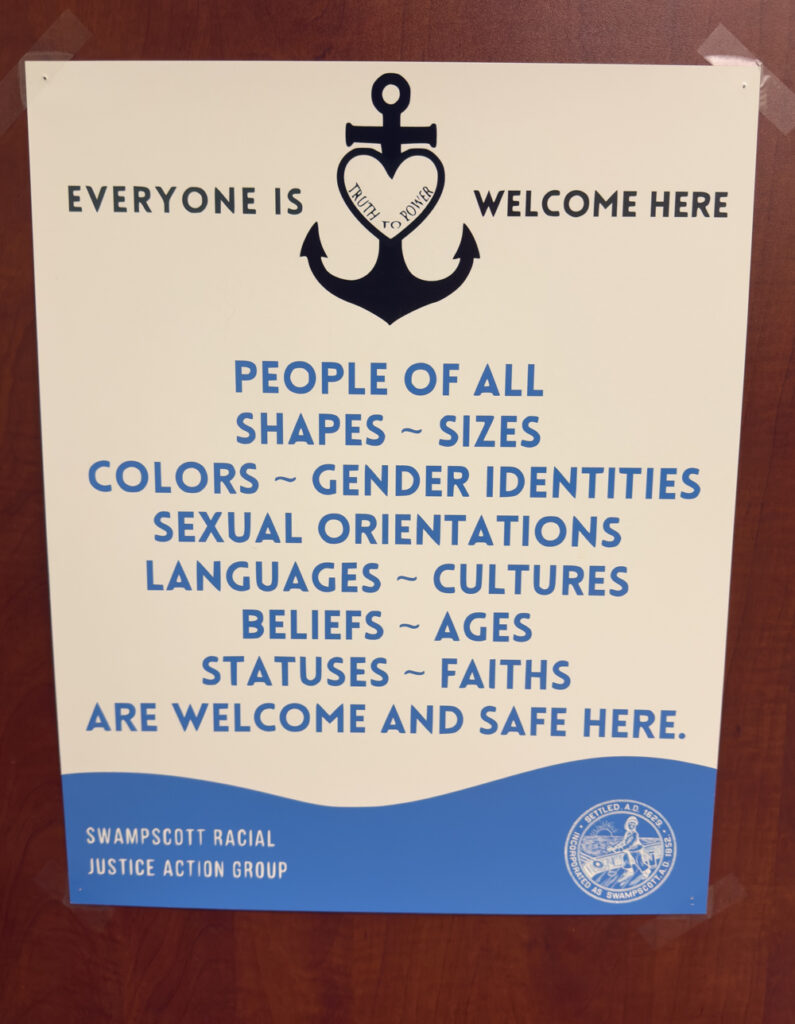 This is a photo of a poster in a doctor's office. The poster welcomes all people without restriction into a safe environment.